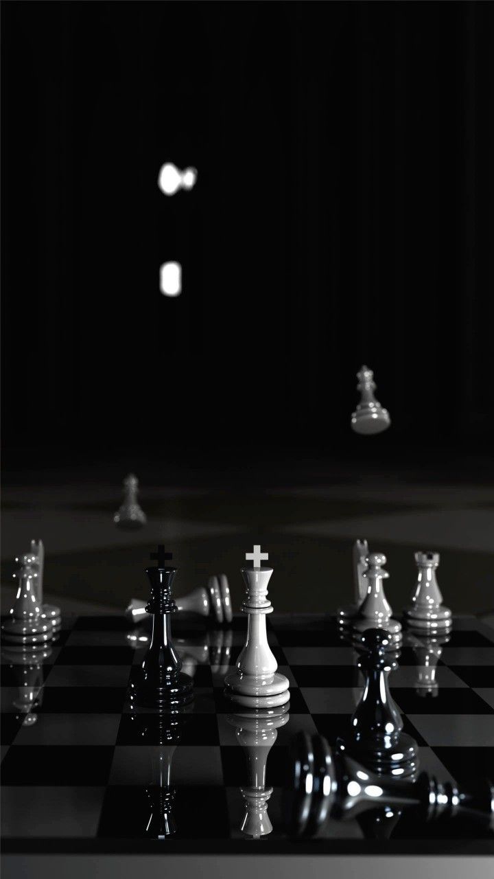 Reflective black and white chess pieces in a dark studio