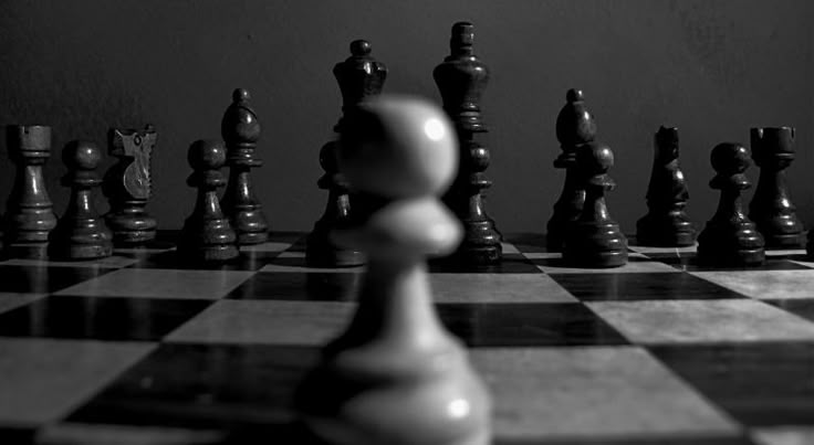 A pawn in foreground facing a line of pieces